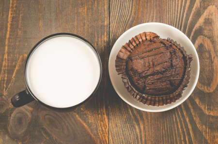 chocolate muffin and milk/chocolate muffin and milk on a wooden background. Top viewの写真素材