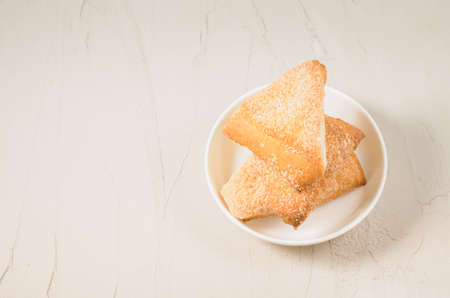 homemade cookies on a white bowl/homemade cookies on a white bowl on a concrete background. Top view and copy spaceの写真素材
