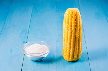 boiled appetizing corn and salt on a blue wooden background, close up. Vegetarian concept. Selective focus. Healthy food.の写真素材