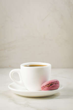 sweet macaroons or macaron and coffee cup on a white background, selective focus. French dessertの写真素材
