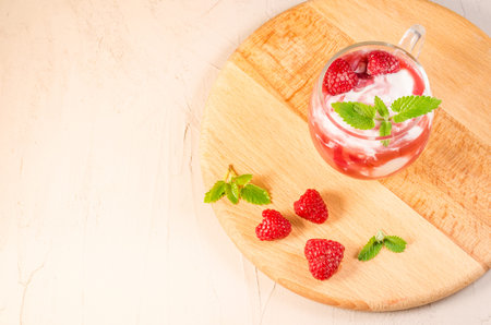 glass of raspberry smoothie with mint/glass of raspberry smoothie with mint on a wooden tray....