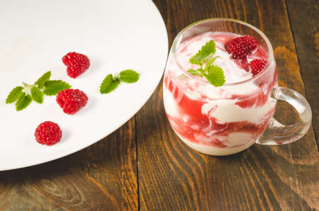 glass of raspberry smoothie with mint/glass of raspberry smoothie with mint on a wooden background. Healthy breakfast.の写真素材