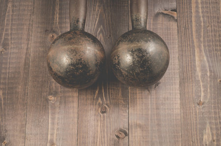 Dumbbells in fitness gym/Dumbbells in fitness gym on a dark wooden background, top view