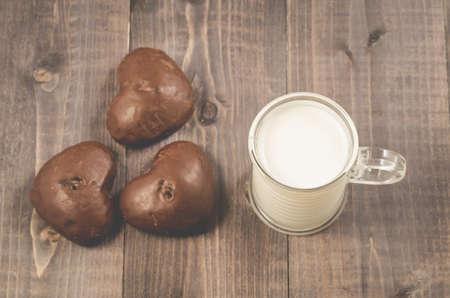 milk with chocolate gingerbreads/milk with chocolate gingerbreads on a dark wooden background. Top viewの写真素材