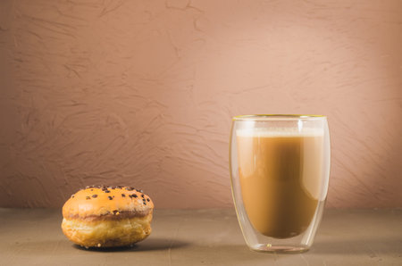 Donut in glaze and a cappuccino