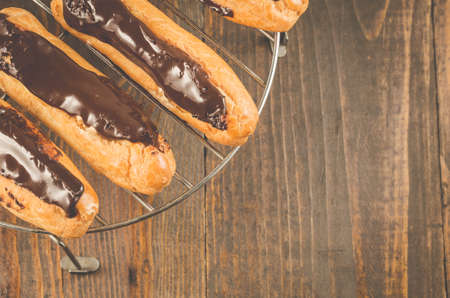 Fresh eclairs on a woodenの写真素材