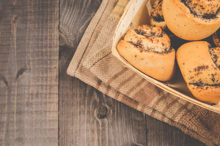 Fresh rolls with poppy a wooden boxの写真素材