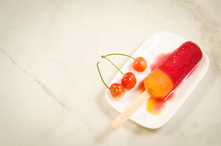 ice cream with sweet cherry/ice cream with sweet cherry on a mareble background. Top view and copyspaceの写真素材