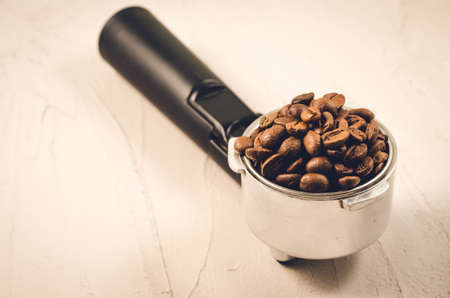 Filter holder and roasted beans coffee/Filter holder and roasted beans coffee on a concrete background. Selective focus and copyspaceの写真素材