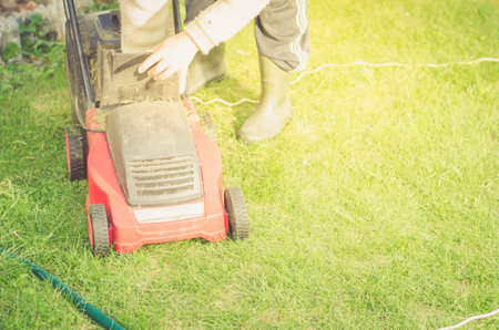 lawn mower is cleaned from a grass/lawn mower is cleaned from a grass. Copyspace
