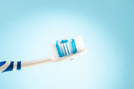 damp toothbrush on a blue background, close upの写真素材