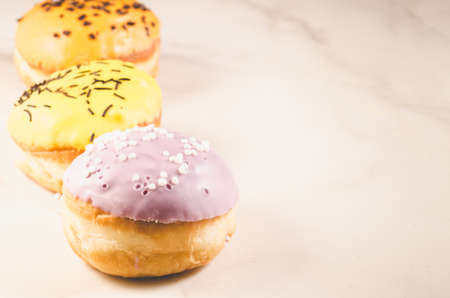 Donuts. Assorted donuts lying on a white table, copy space. Selective focus. Ð¡oncept sweet food.の写真素材