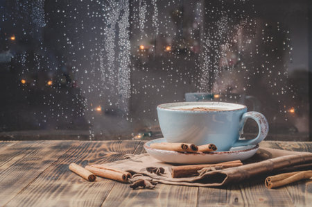 Eggnog. Traditional christmas cocktail in a blue mug with cinnamon sticks and anise on napkin and...
