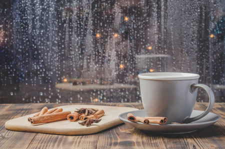 Eggnog. Traditional christmas cocktail in a mug with cinnamon sticks and anise on napkin and wooden table.の写真素材