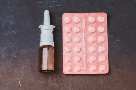 Drug spray bottle and pills packages on black background/Drug spray bottle and pills packages....