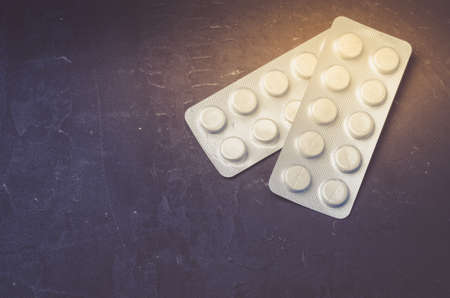 Two pills packages on black background/Packages of pills are placed on a black background. Top view and copyspaceの写真素材