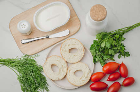 Healthy food with round toast, bottle, vegetables and cheese/Healthy food with round toast, bottle, vegetables and cheese on white table. Top view.の写真素材