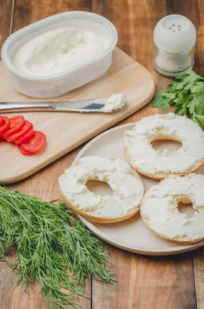 Vegetarian food with round toast, vegetables and cheese on wooden table/Healthy food with round toast, vegetables and cheese on wooden table. Top viewの写真素材