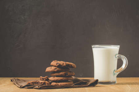 Chocolate cookies and glass of milk/Chocolate cookies and glass of milk dark background. Selective focusの写真素材