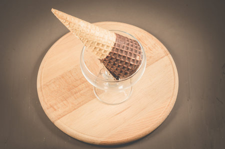 ice cream with cone in chocolate in a glass ice cream parlor/ice cream with cone in chocolate in a...