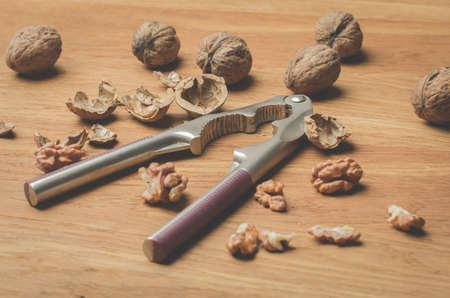 Walnut. A shell and nutcracker on a wooden tableの写真素材