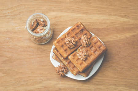 Wafers. Home made pastries, wafers and walnut in a glass jar on a wooden table. Top viewの写真素材