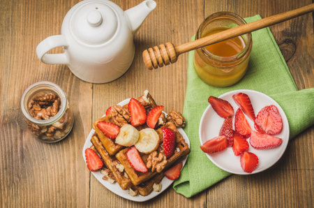 Breakfast. The wafers decorated with strawberry, banana and walnut with honey. Top viewの写真素材