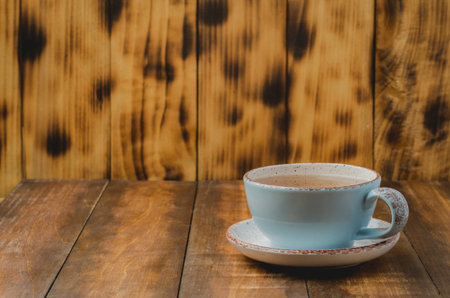 Blue cup of tea on wooden background, selective focus and copyspace for text