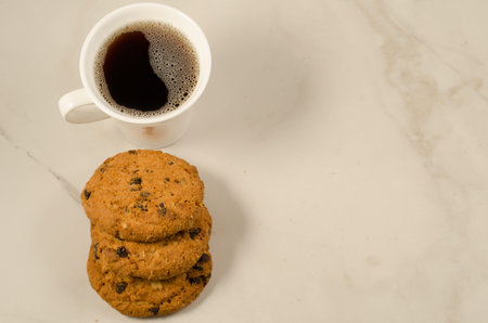 coffee cup and homemade cookies with chocolate/coffee cup and homemade cookies with chocolate on a marble background, top view and copyspaceの写真素材
