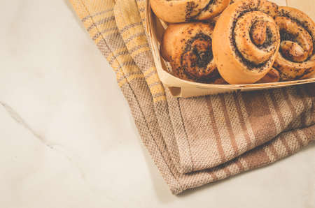 fresh rolls with poppy a wooden box/fresh rolls with poppy a wooden box on a white marble table. Top view and copy spaceの写真素材