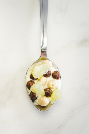 Healthy food concept. Yogurt, flakes and citrus in a spoon. Top view, flatlay 