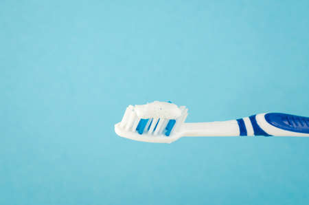 toothbrush with toothpaste on a blue backgroundの写真素材