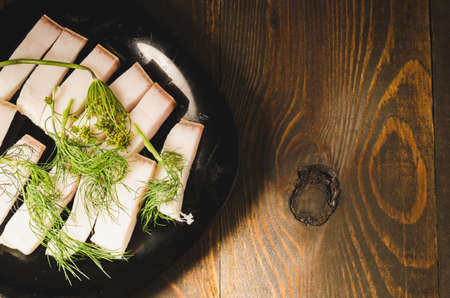 national Ukrainian dish fat with fennel on a wooden table, top view and copy spaceの写真素材
