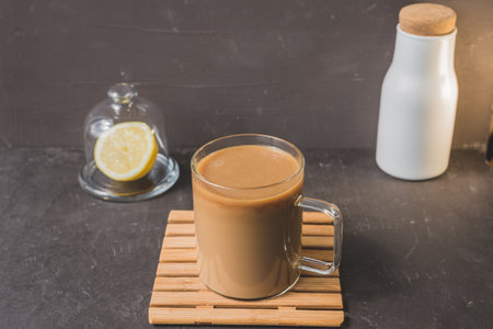 glass with coffee on wooden tray on dark background / glass with coffee on wooden tray on dark bar counterの写真素材