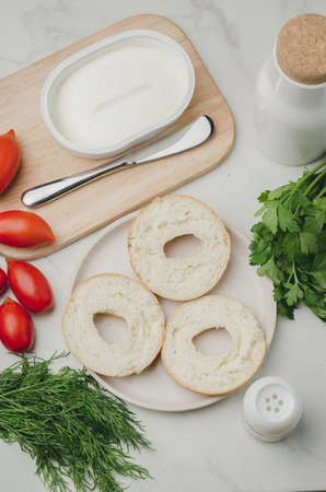 Vegetarian food with round toast, bottle, vegetables and cheese / Healthy food with round toast, bottle, vegetables and cheese on white table. Top view.の写真素材