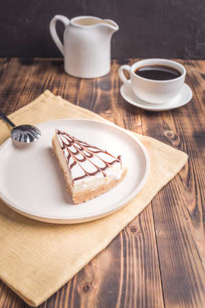 Dessert with coffee and cream in a white dish on a dark wooden table.の写真素材