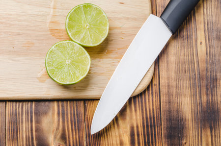 Sliced ââlimes on a wooden kitchen table. Top view.の写真素材