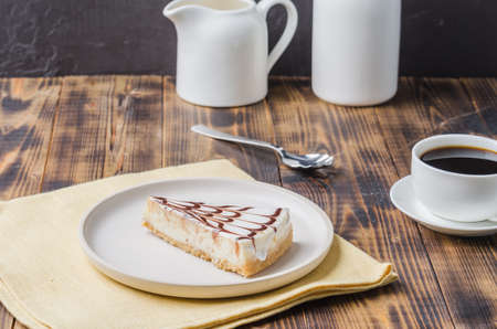 Dessert with coffee and cream in a white dish on a dark wooden table.の写真素材