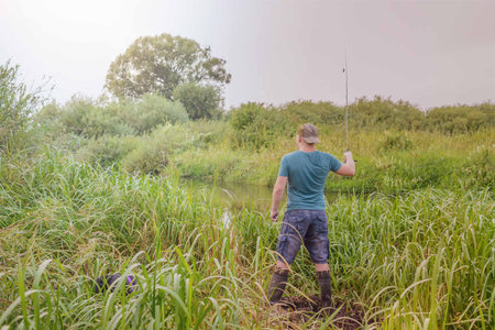 Fisherman throws tackle. Summer fishing on the river.