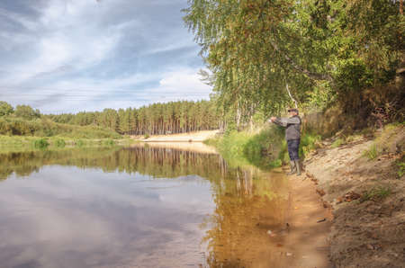 Fisherman on the bank of a beautiful river. beautiful scenery.の写真素材