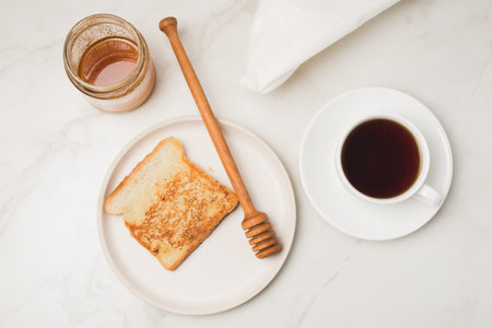 Croutons for breakfast with honey and coffee on a white background. top view.