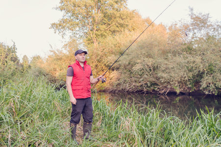 Sport fishing on the river. Angler throws tackle.の写真素材