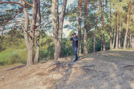 Man nature photographer taking pictures in the forest.の写真素材