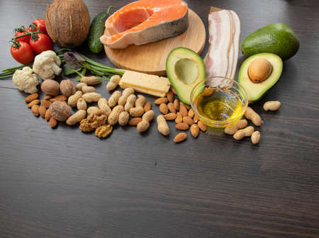 Keto diet.Healthy food set. Fish, nuts, protein, vegetables and fruits. On a black wooden background. View from above. Free space for text.の写真素材