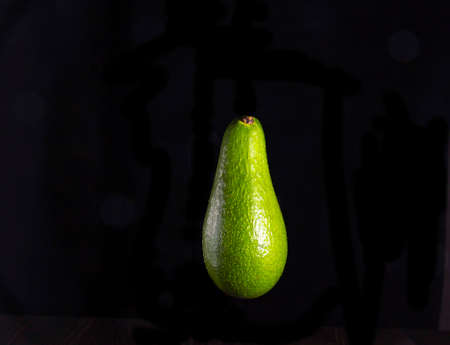 Freshly cut ripe avocado isolated on black.の写真素材