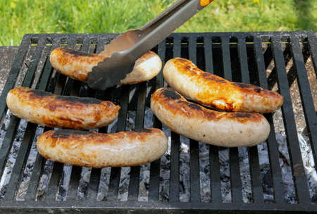 Grilled sausages on the grill. Barbecue in the garden. Bavarian sausages.の写真素材