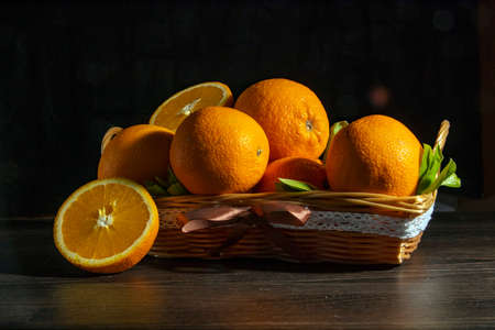Fresh fragrant oranges on a wooden table on a black background.の写真素材