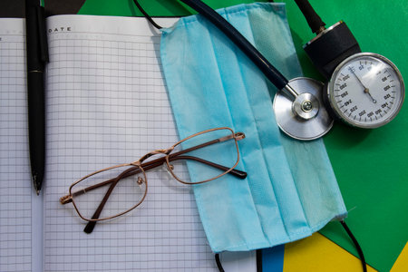 blue antibacterial medical mask, thermometer and pills on a colored background; viral epidemic protection against coronavirus Covid-19.の写真素材