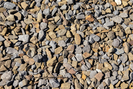 View from above. Background natural gray granite crushed stone, macadam. Macro photo of texture of...