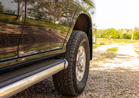 The tire by car. Close-up. Selective focus.